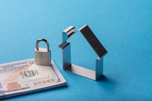 high-angle-banknotes-with-lock-house_23-2148569110